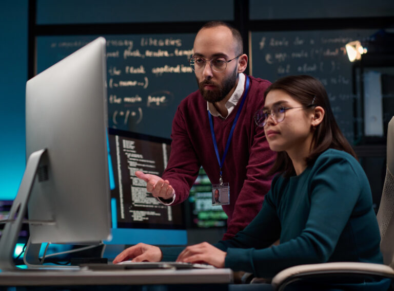 Teacher and student at computer